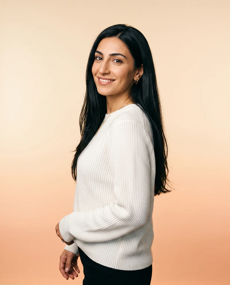 Portrait of Ani, a woman in a white knit sweater