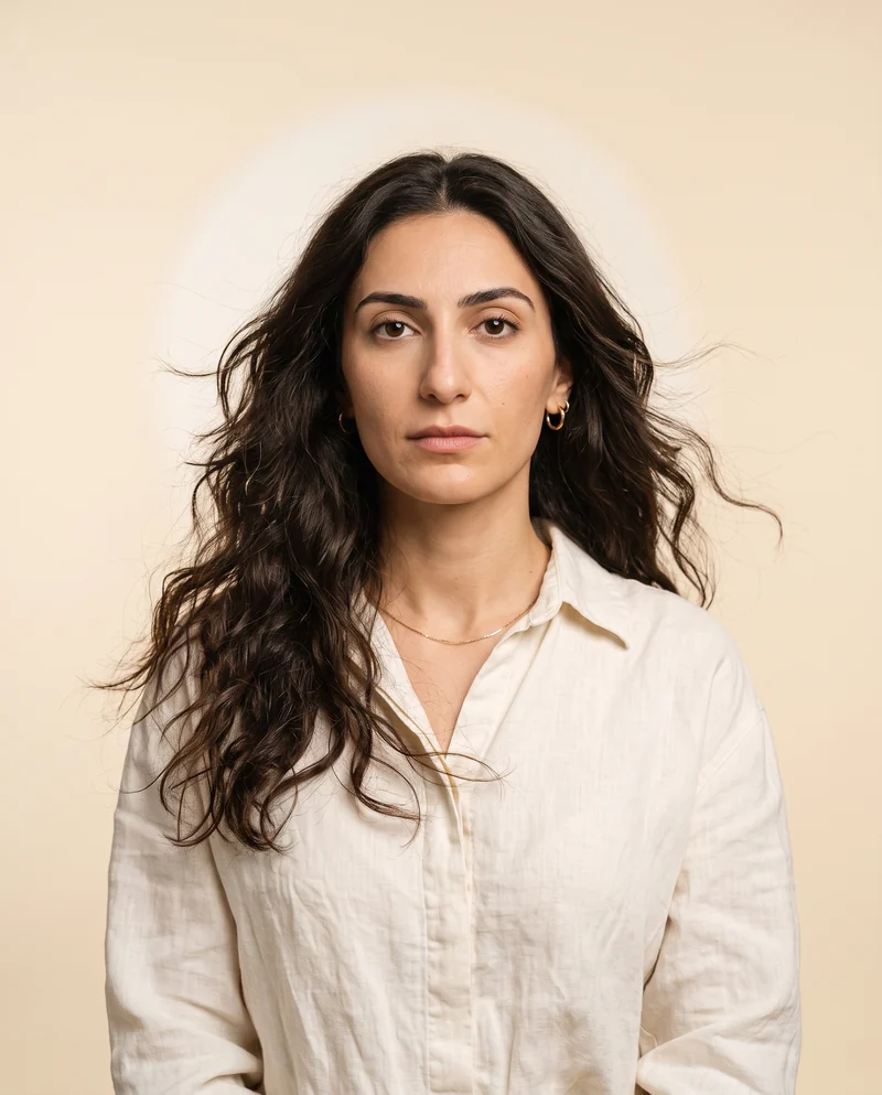 Portrait of Mariam, a woman in an off white linen shirt